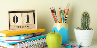 colorful notebooks and back-to-school supplies with a calendar showing September 1st